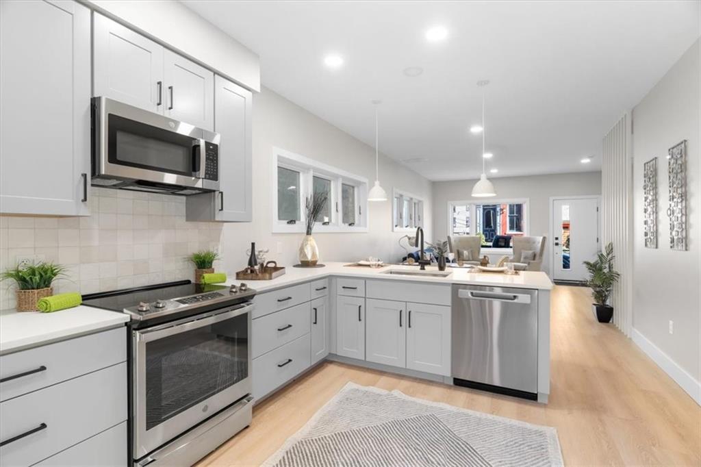 1213 Boyle Street Pittsburgh, PA 15212 - Photo 7 of 31 a kitchen with stainless steel appliances a stove microwave sink and cabinets