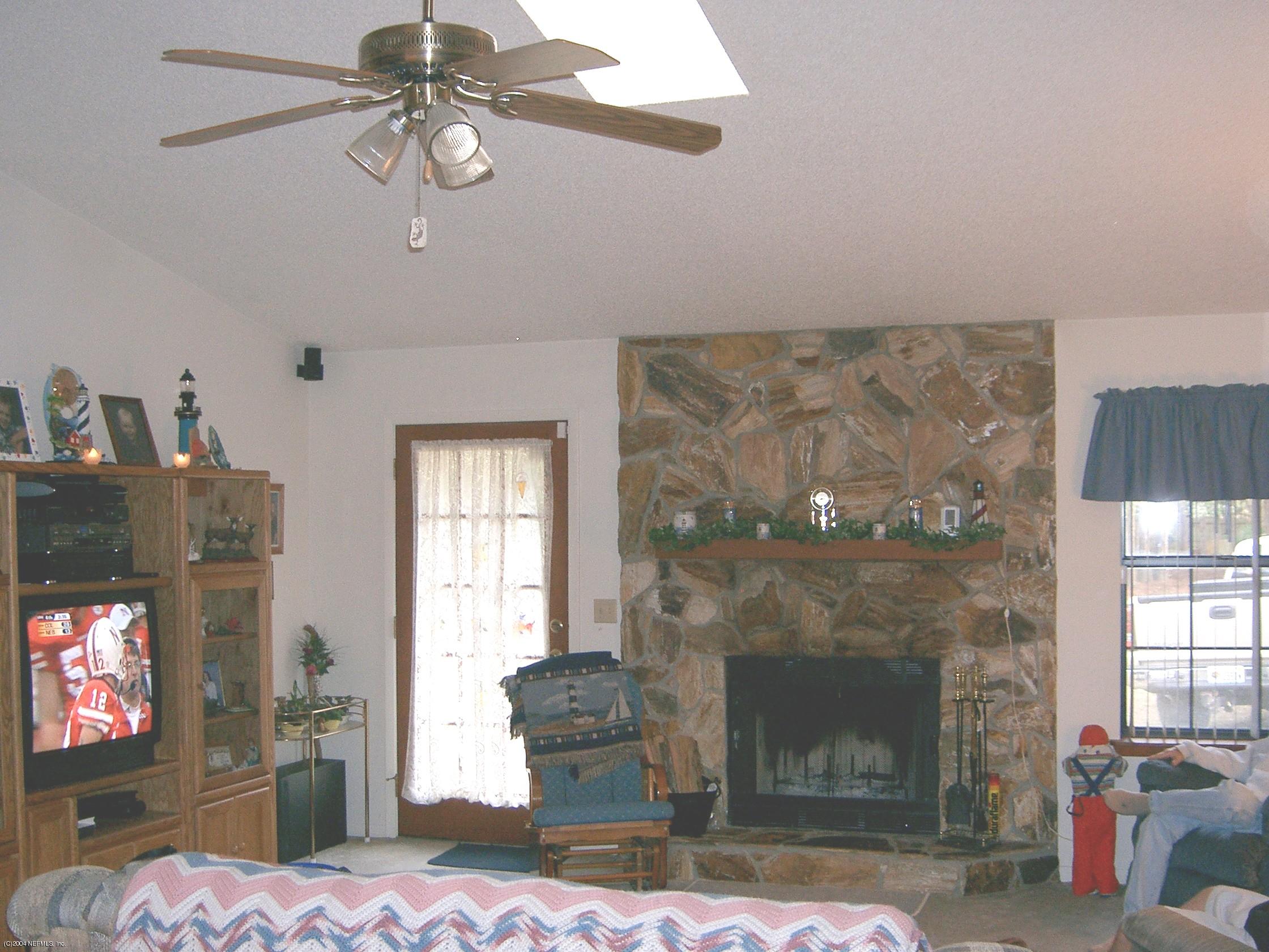 1137 Cactus Cut Road Middleburg, FL 32068 - Photo 2 of 6 a living room with furniture and a fireplace
