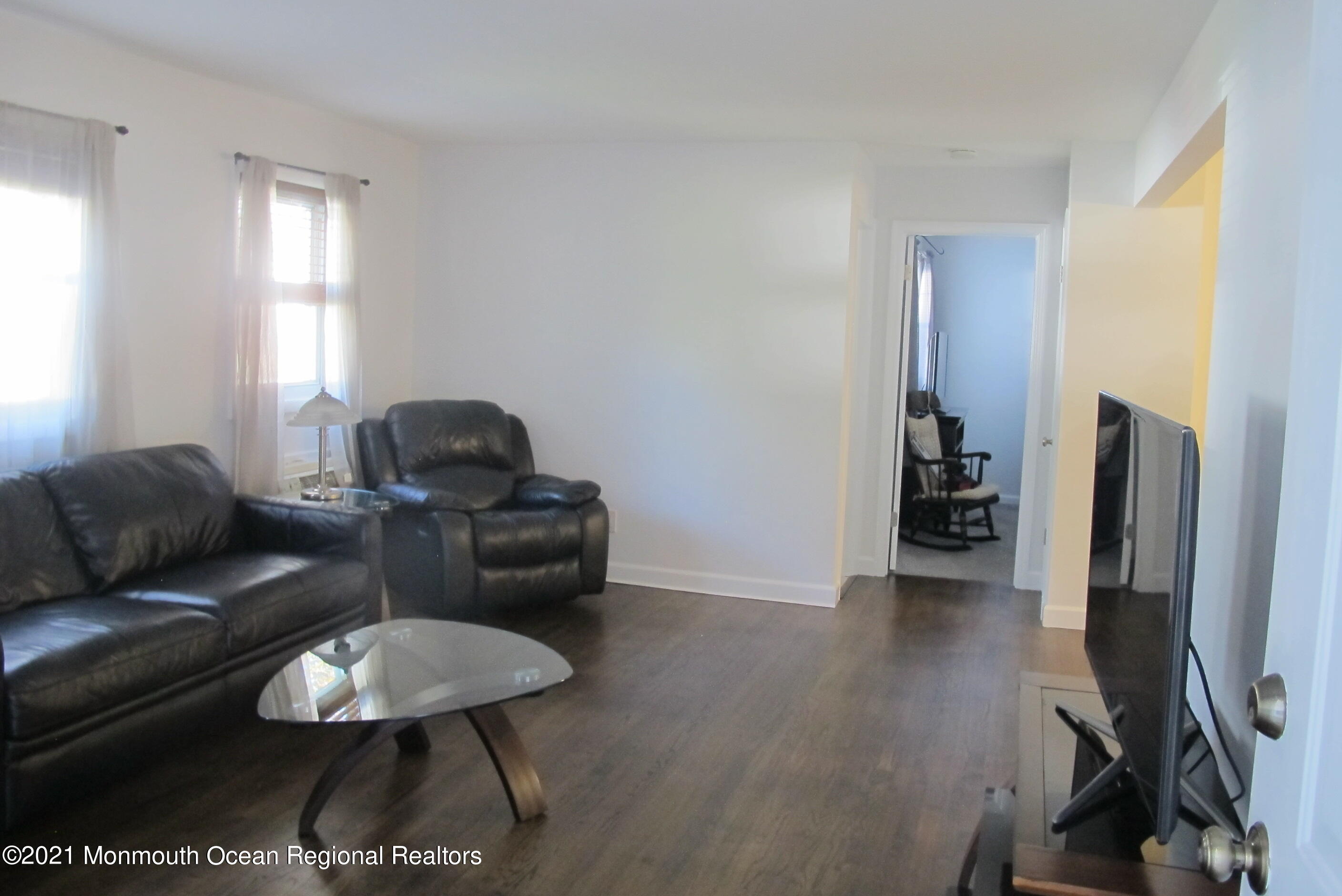 601 Mistletoe Avenue, Unit 14 Point Pleasant, NJ 08742 - Photo 2 of 8 a living room with furniture and a flat screen tv