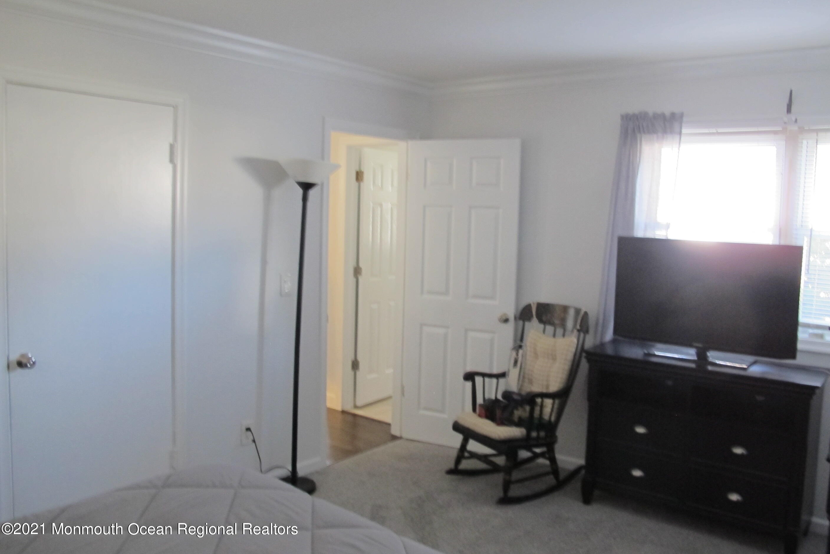 601 Mistletoe Avenue, Unit 14 Point Pleasant, NJ 08742 - Photo 6 of 8 a room with furniture and a flat screen tv