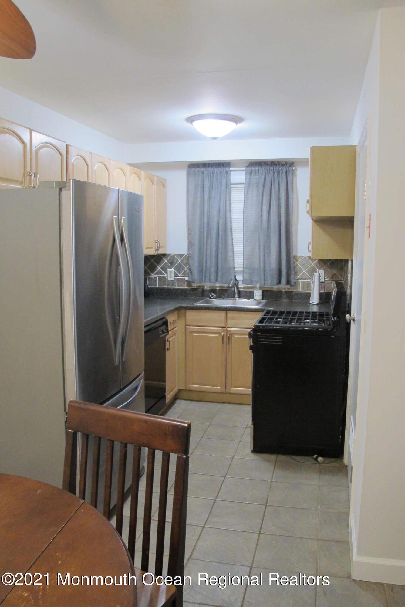 601 Mistletoe Avenue, Unit 14 Point Pleasant, NJ 08742 - Photo 7 of 8 a kitchen with stainless steel appliances granite countertop a refrigerator a sink a stove with wooden cabinets
