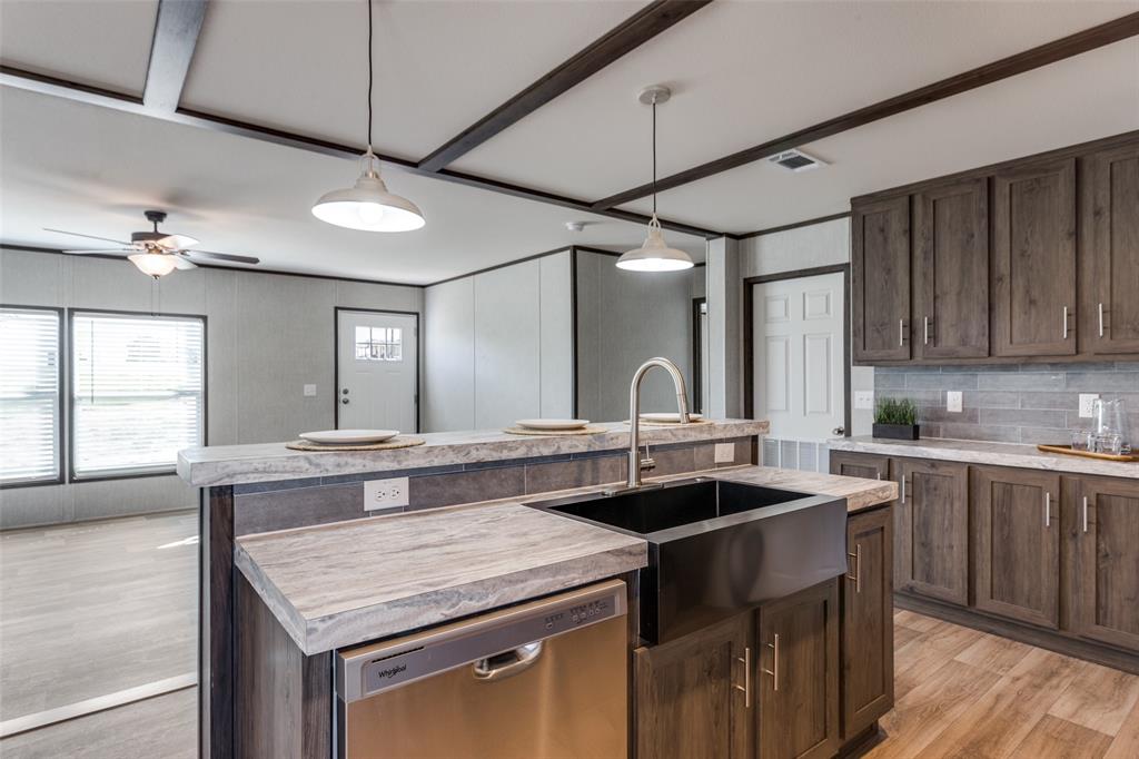 175 Cedar Drive Azle, TX 76020 - Photo 13 of 25 a kitchen with a sink a counter space cabinets and appliances