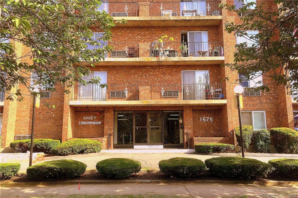 1575 Boston Avenue, Unit C16 Bridgeport, CT 06610 - Photo 1 of 1 front view of a building with a garden