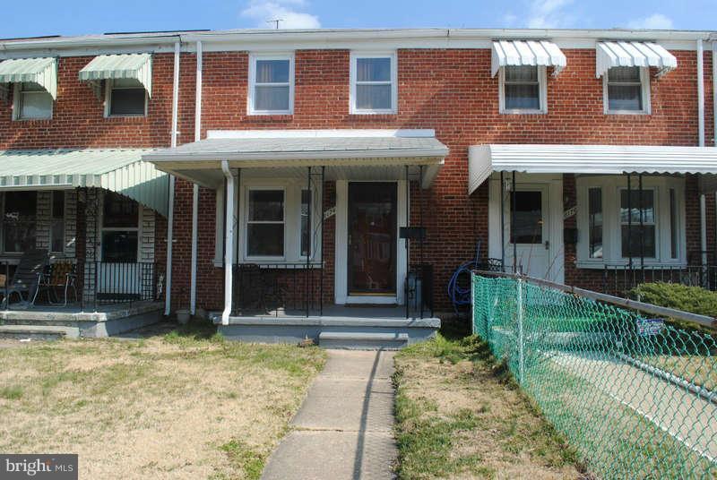 a view of a brick house with large windows