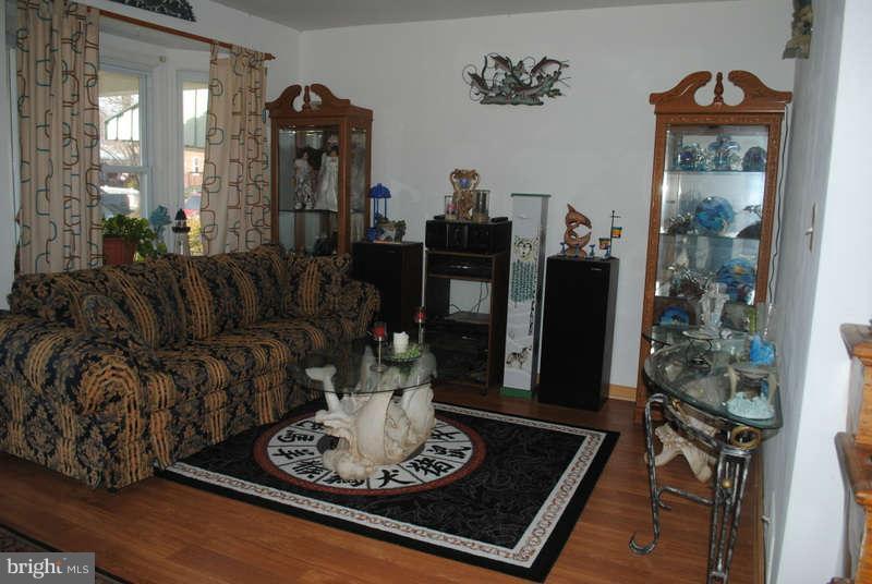 8174 Kavanagh Road Baltimore, MD 21222 - Photo 2 of 19 a living room with furniture and a fireplace