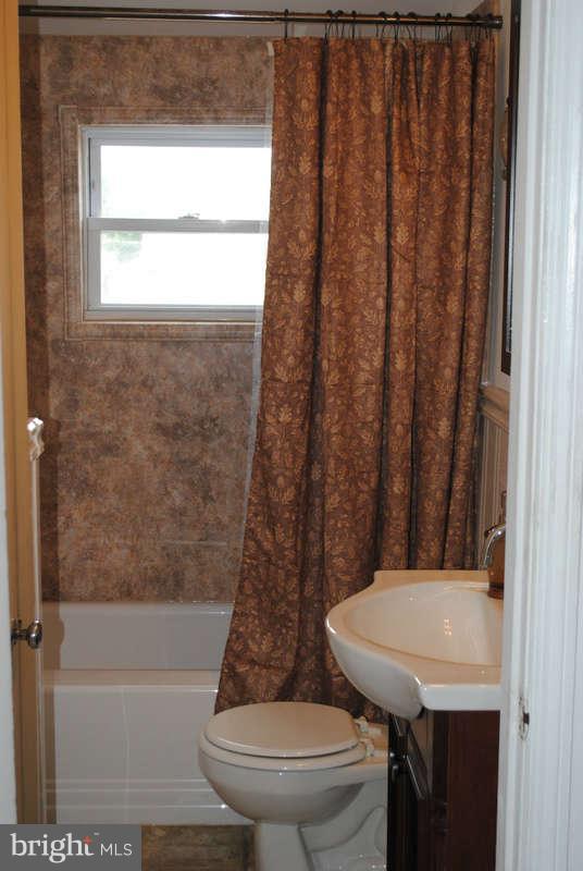 8174 Kavanagh Road Baltimore, MD 21222 - Photo 12 of 19 a bathroom with a sink toilet and shower