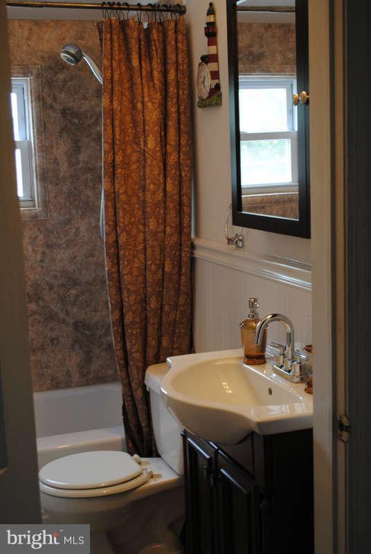 8174 Kavanagh Road Baltimore, MD 21222 - Photo 13 of 19 a bathroom with a sink and a mirror