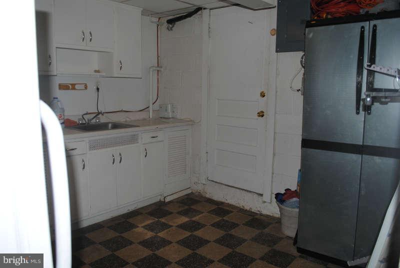 8174 Kavanagh Road Baltimore, MD 21222 - Photo 15 of 19 a bathroom with a granite countertop sink and a mirror