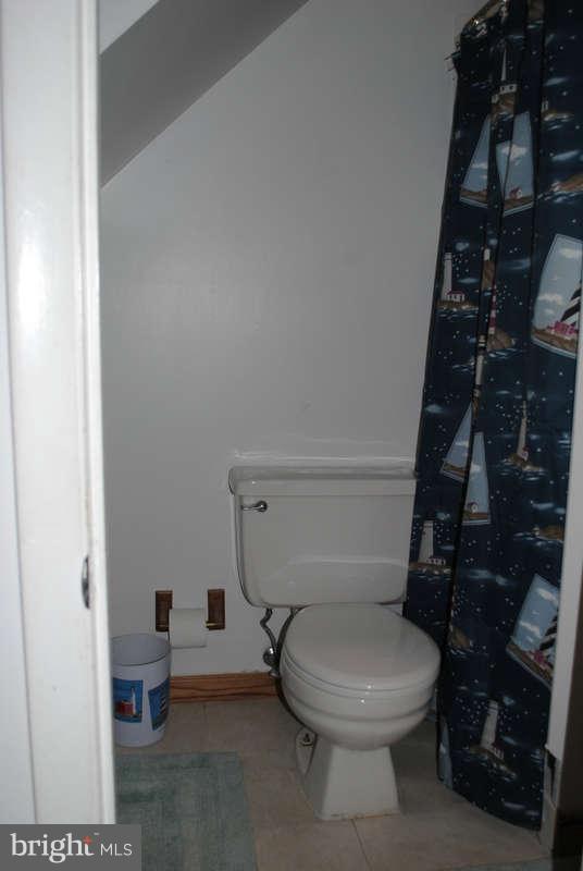 8174 Kavanagh Road Baltimore, MD 21222 - Photo 16 of 19 a bathroom with a toilet and a shower