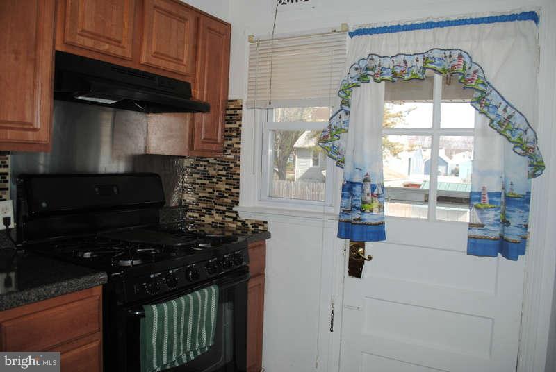 8174 Kavanagh Road Baltimore, MD 21222 - Photo 9 of 19 a kitchen with a sink and a stove