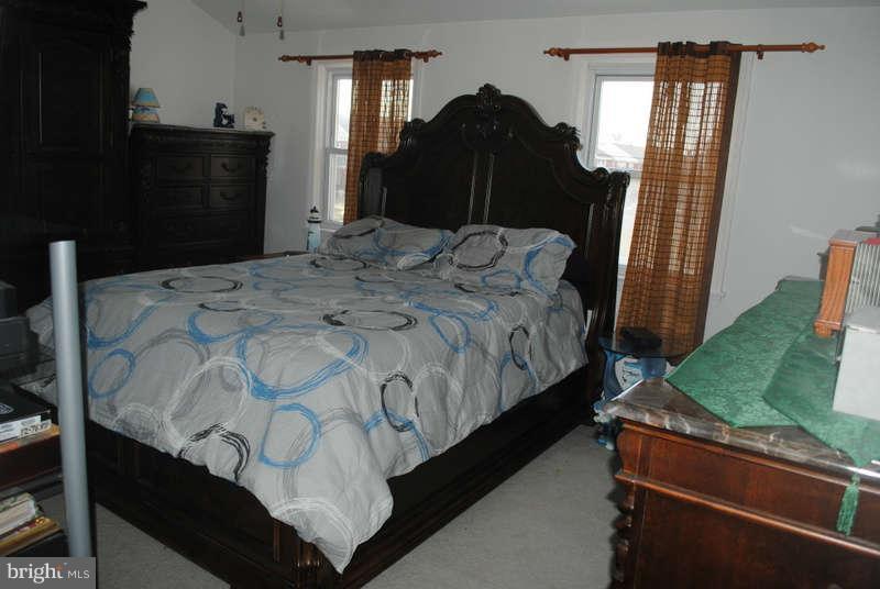 8174 Kavanagh Road Baltimore, MD 21222 - Photo 10 of 19 a bedroom with bed mirror and window