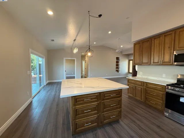 a kitchen with kitchen island a sink stainless steel appliances and cabinets
