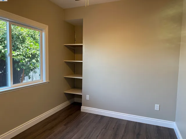 a view of a room with wooden floor and window
