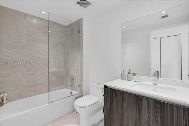 a kitchen with a sink cabinets and wooden floor