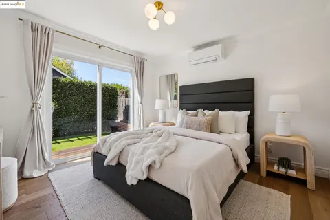 a bedroom with a bed and a large window