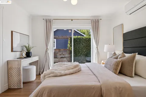 a bedroom with a balcony a bed and a fireplace