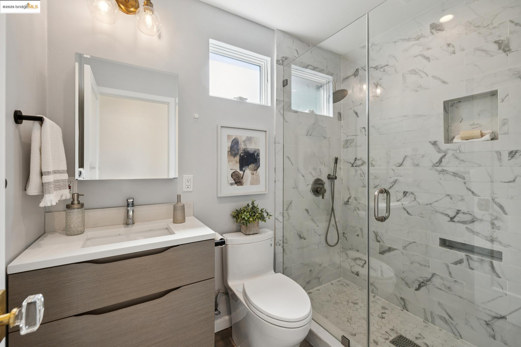 1642 Tenth Street Berkeley, CA 94710 - Photo 17 of 51 a bathroom with a sink toilet a mirror and shower