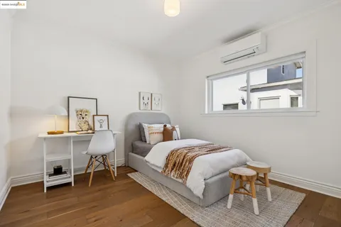 a bedroom with a bed a table and chair