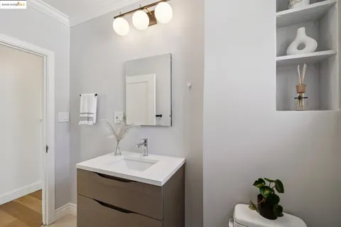 a bathroom with a sink a mirror and vanity