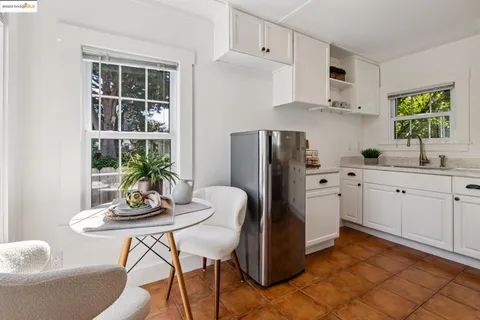 a kitchen with stainless steel appliances a dining table and chairs