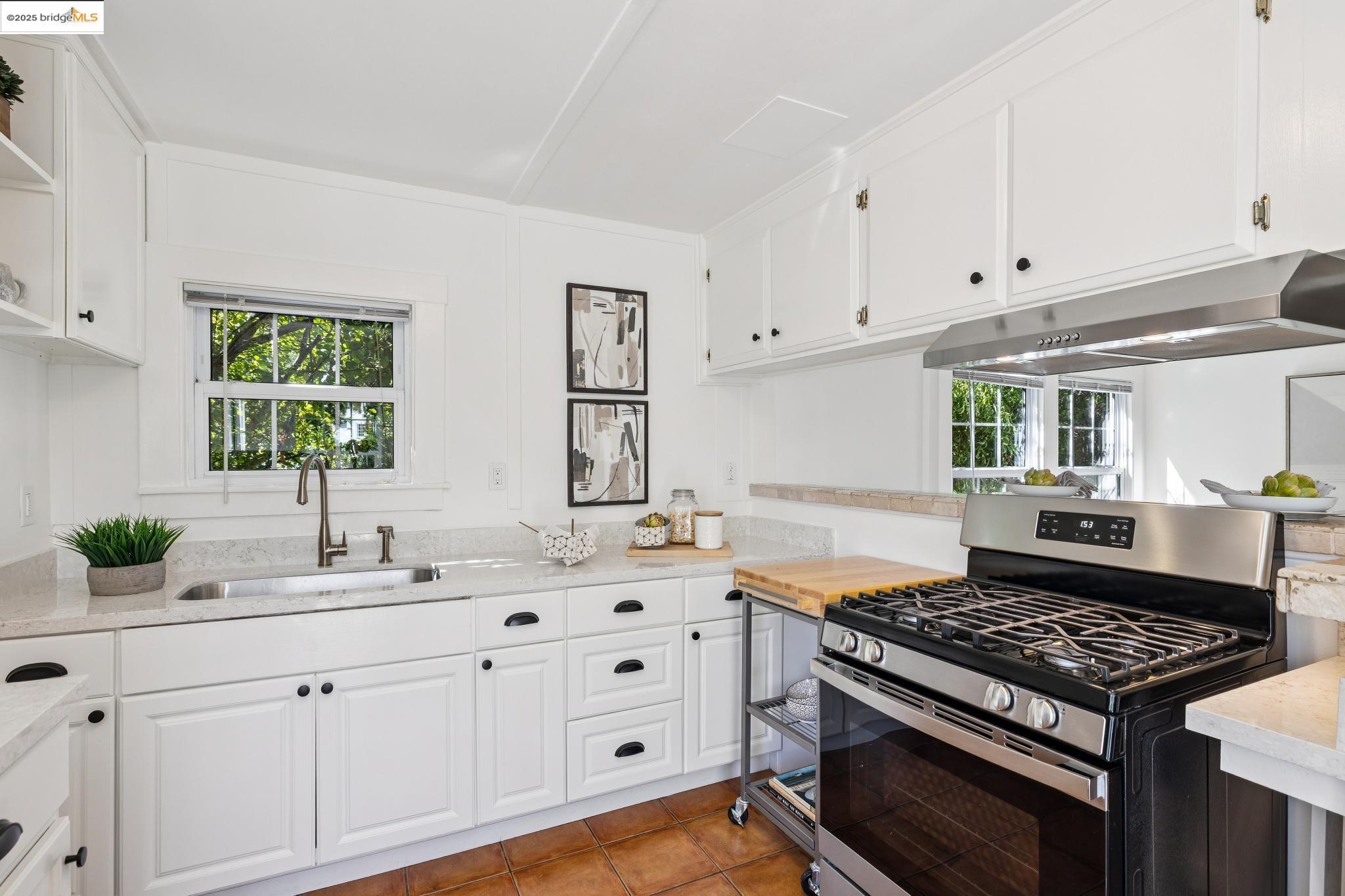 1642 Tenth Street Berkeley, CA 94710 - Photo 32 of 51 a kitchen with white cabinets and appliances