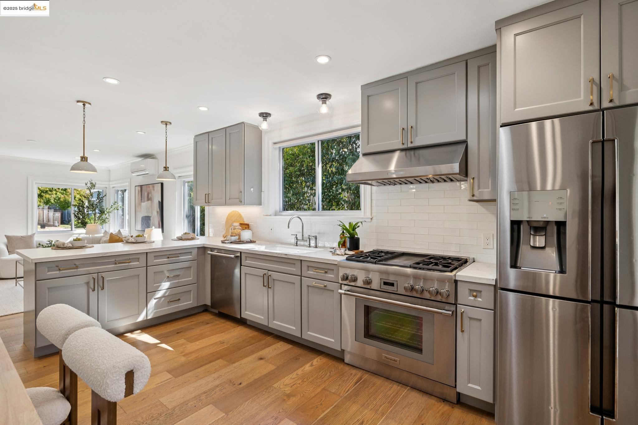1642 Tenth Street Berkeley, CA 94710 - Photo 9 of 51 a kitchen with stainless steel appliances a stove a sink and a refrigerator
