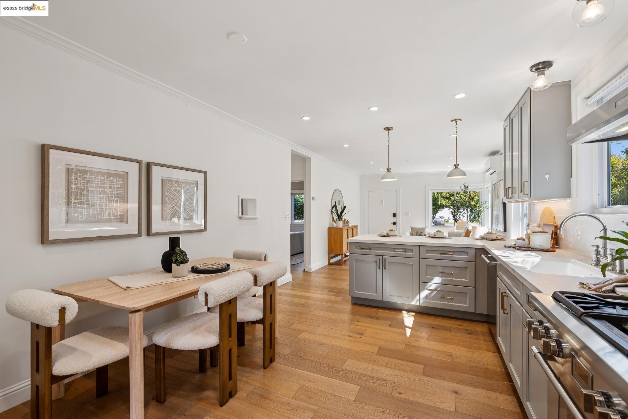 1642 Tenth Street Berkeley, CA 94710 - Photo 10 of 51 a kitchen with stainless steel appliances granite countertop a stove top oven a sink dishwasher and white cabinets with wooden floor