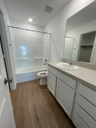 a view of a room with wooden floor