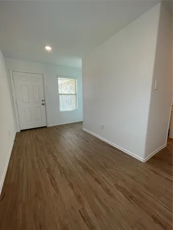 a utility room with wooden floor and windows