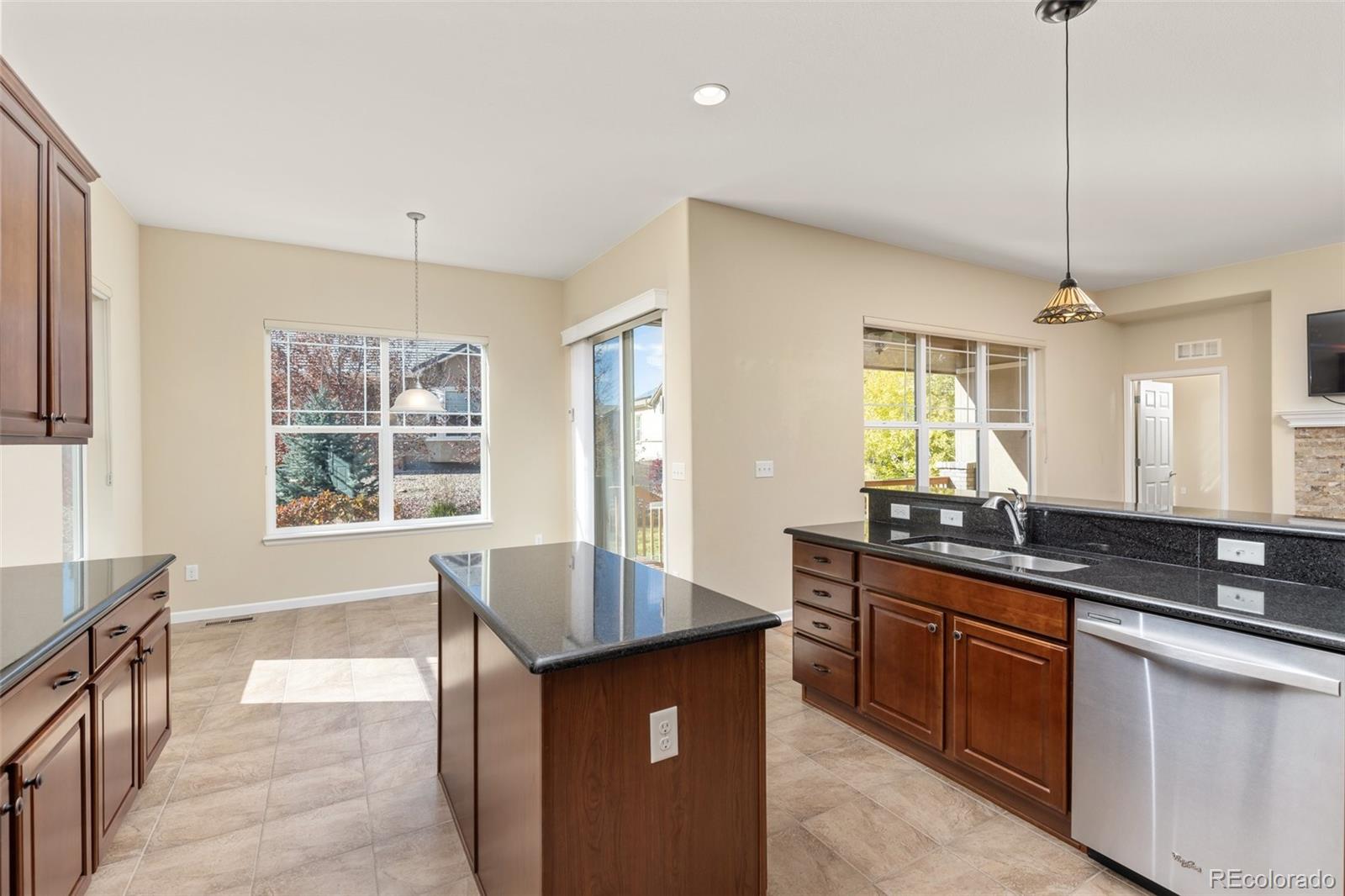 15965 Redcloud Way Broomfield, CO 80023 - Photo 13 of 49 a kitchen with granite countertop a sink and a stove