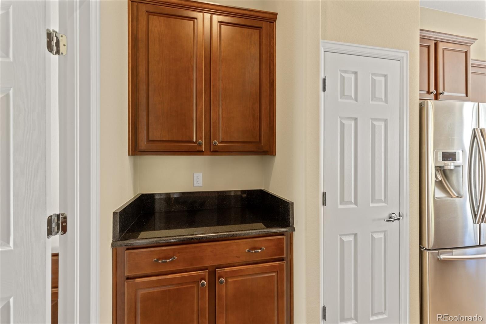 15965 Redcloud Way Broomfield, CO 80023 - Photo 15 of 49 a kitchen with a refrigerator stove and cabinets