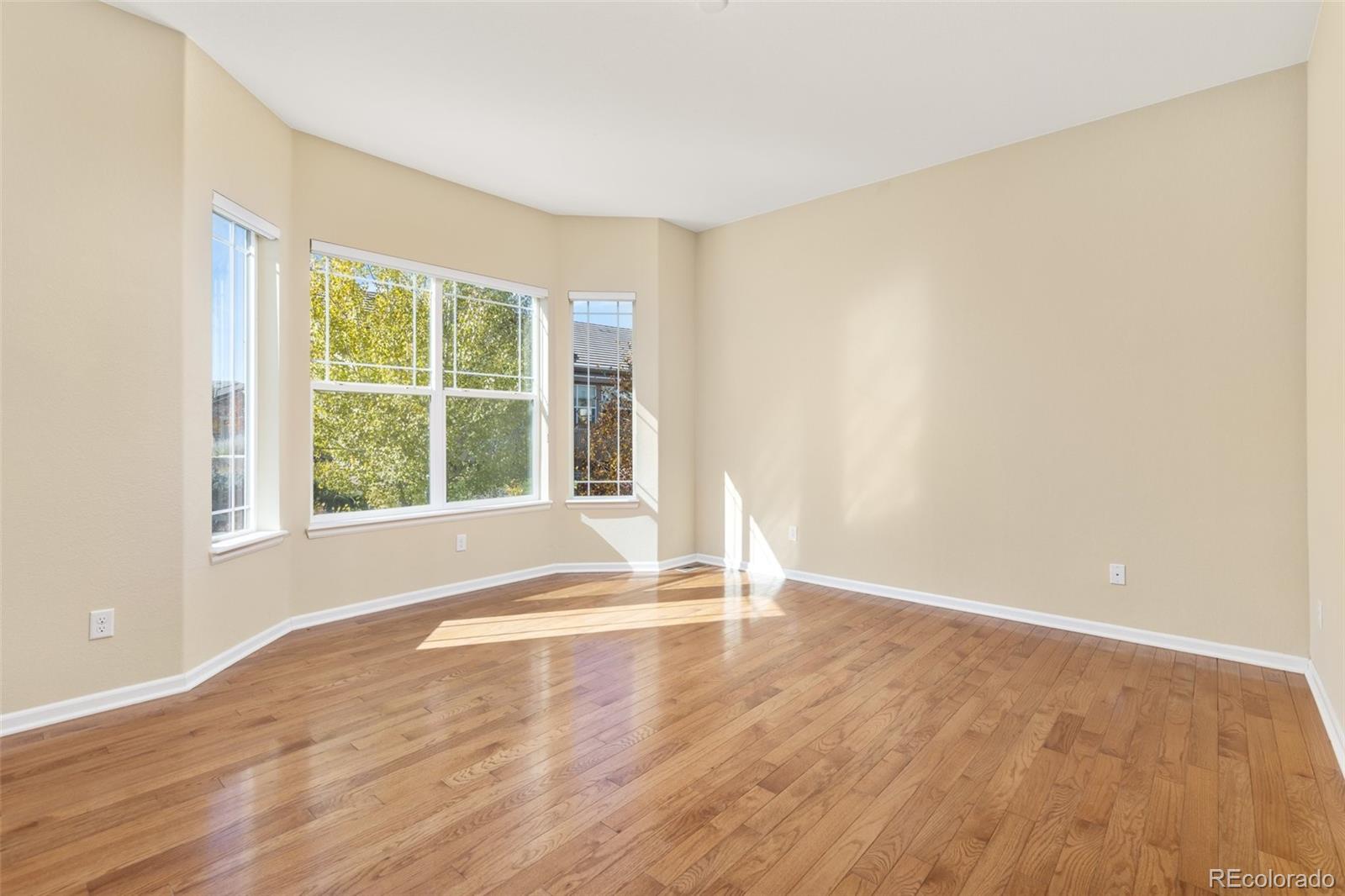 15965 Redcloud Way Broomfield, CO 80023 - Photo 16 of 49 a view of an empty room with wooden floor and a window