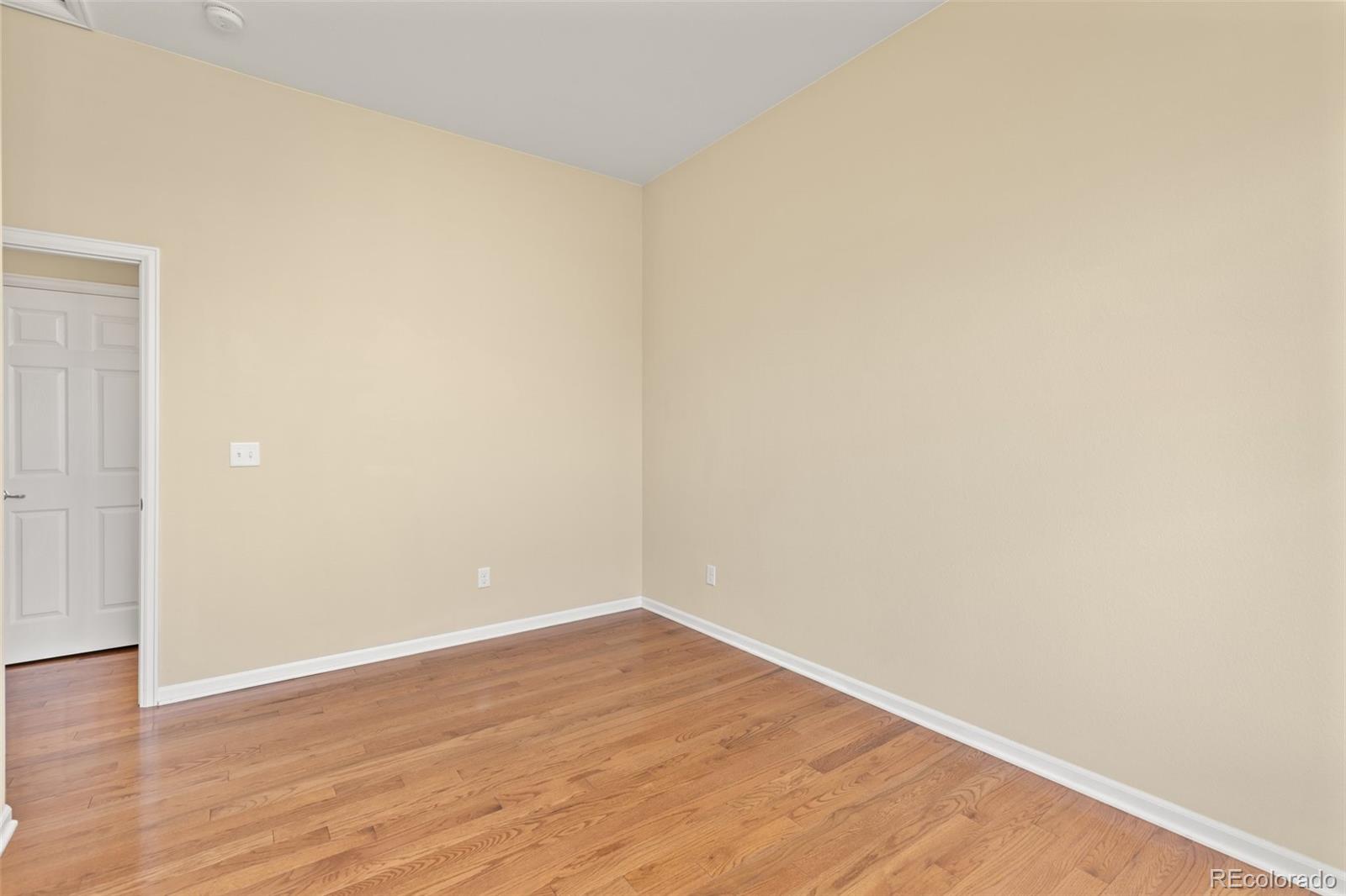 15965 Redcloud Way Broomfield, CO 80023 - Photo 24 of 49 a view of an empty room with wooden floor