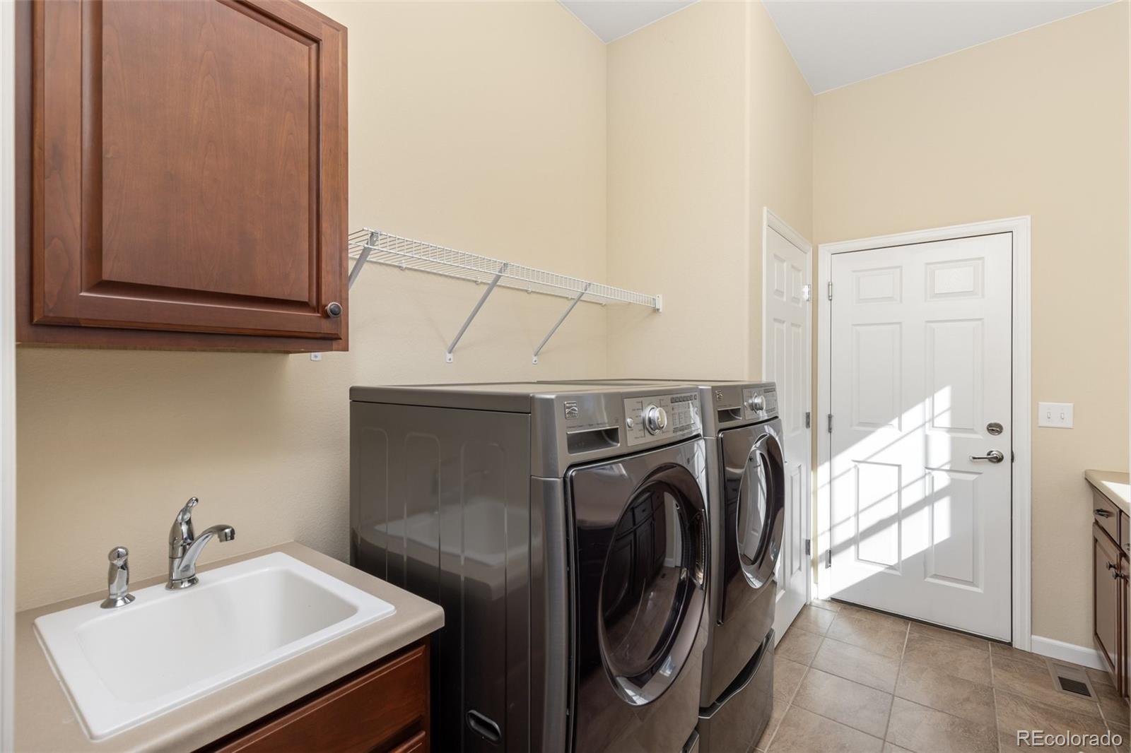 15965 Redcloud Way Broomfield, CO 80023 - Photo 26 of 49 a utility room with dryer and washer