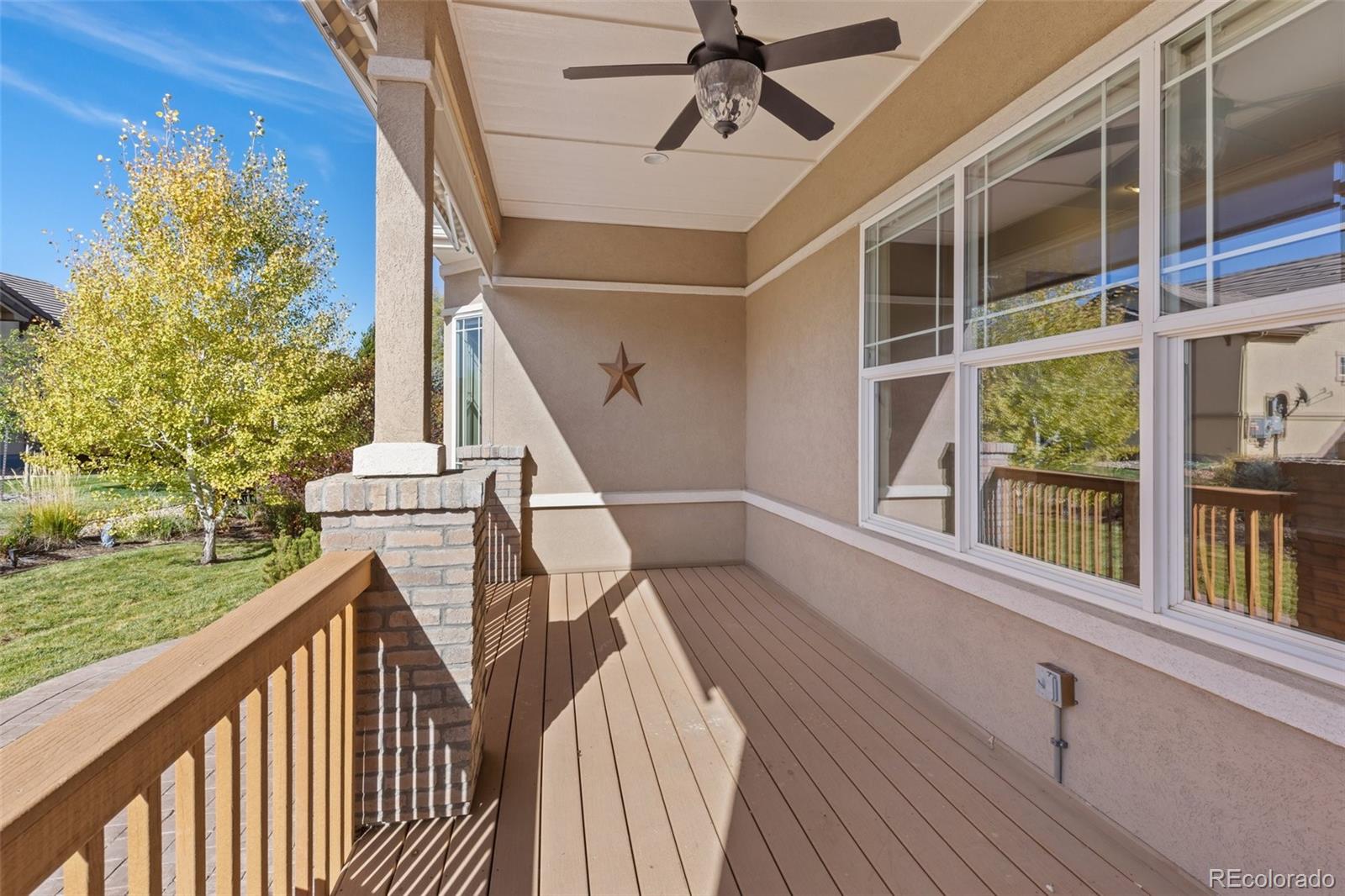 15965 Redcloud Way Broomfield, CO 80023 - Photo 32 of 49 a view of a balcony with wooden floor and fence