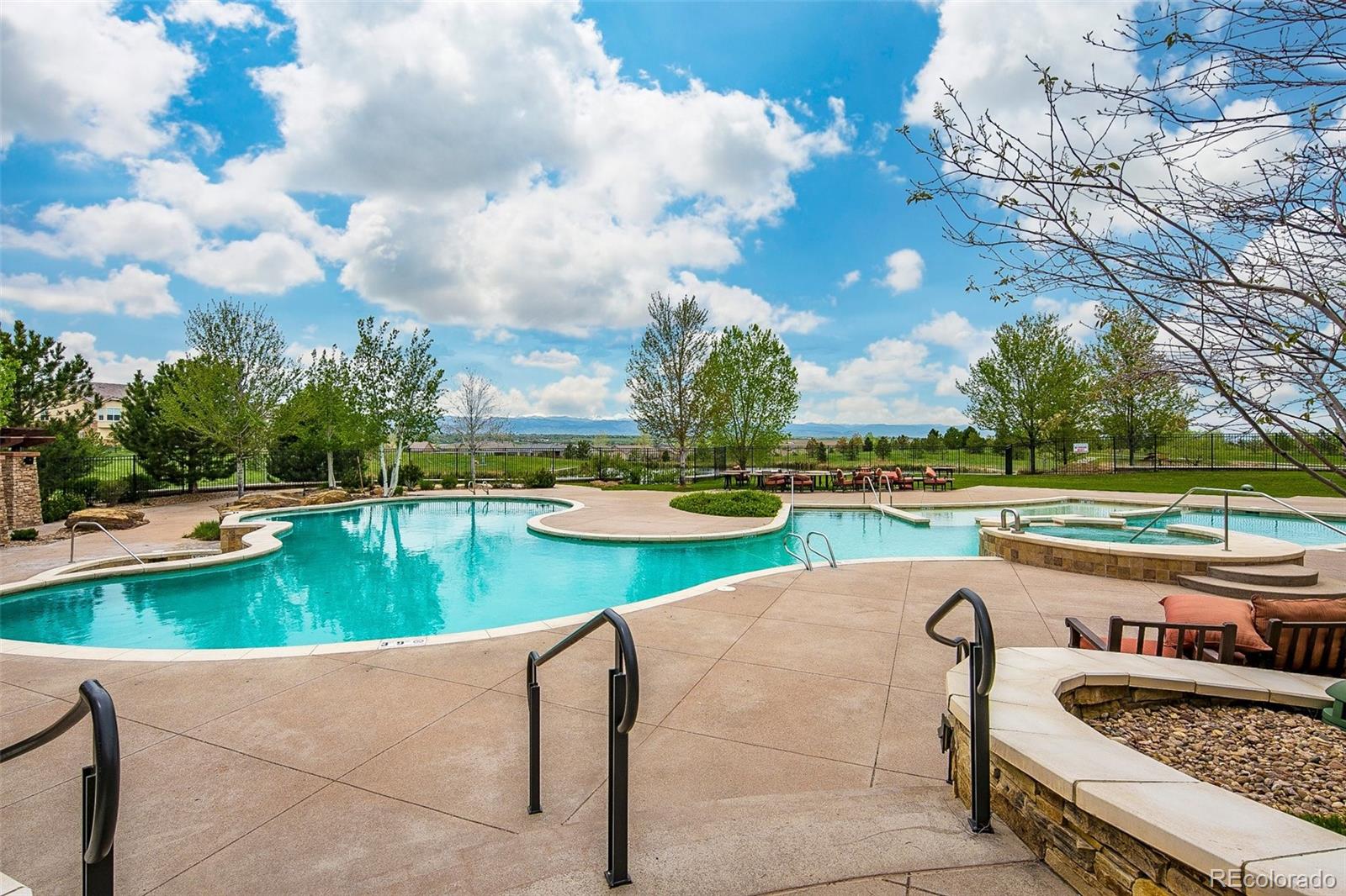15965 Redcloud Way Broomfield, CO 80023 - Photo 40 of 49 a view of a swimming pool and lounge chairs in back yard