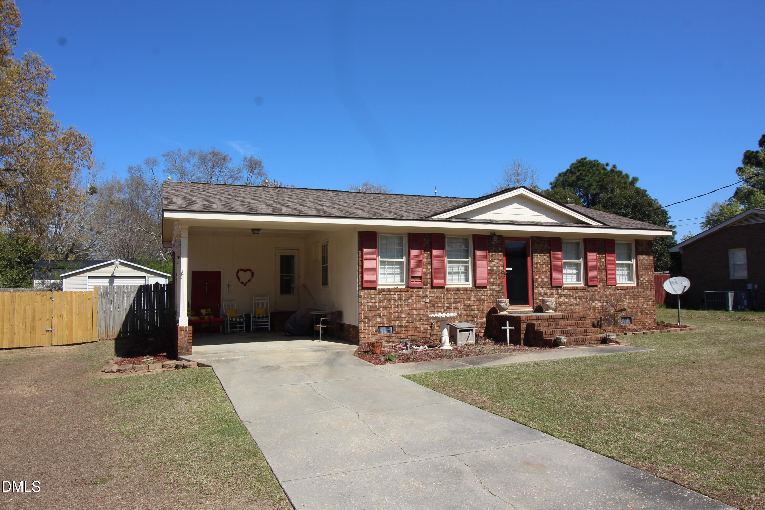 56 Ash Street Coats, NC 27521 - Photo 4 of 28 a front view of a house with a yard and seating space