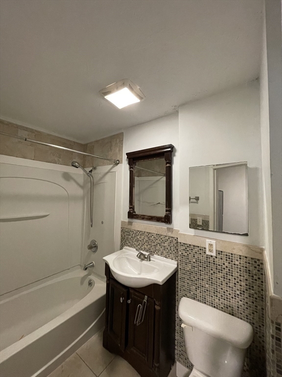 5 Freeland Terrace, Unit 1 Worcester, MA 01603 - Photo 12 of 16 a bathroom with a sink a toilet a mirror and bathtub