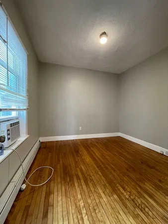 a view of a room with wooden floor and sink