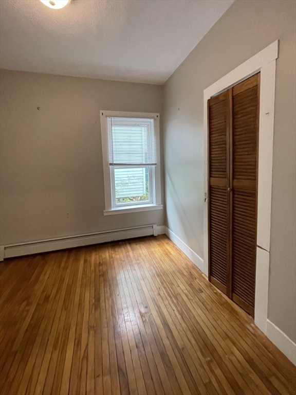 5 Freeland Terrace, Unit 1 Worcester, MA 01603 - Photo 10 of 16 an empty room with wooden floor and windows