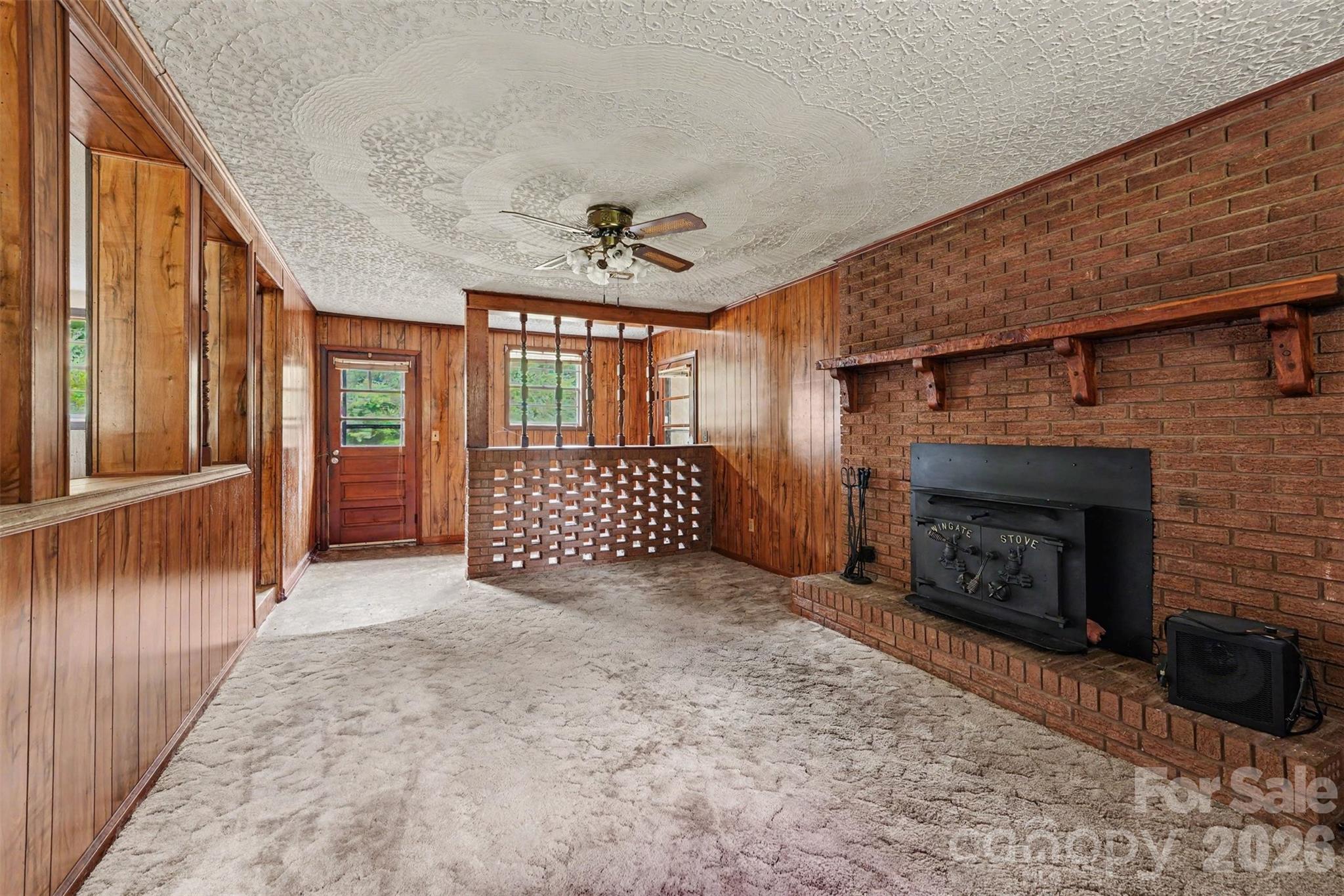 2871 Loviee Road Lincolnton, NC 28092 - Photo 5 of 14 a view of an empty room with a fireplace and a window