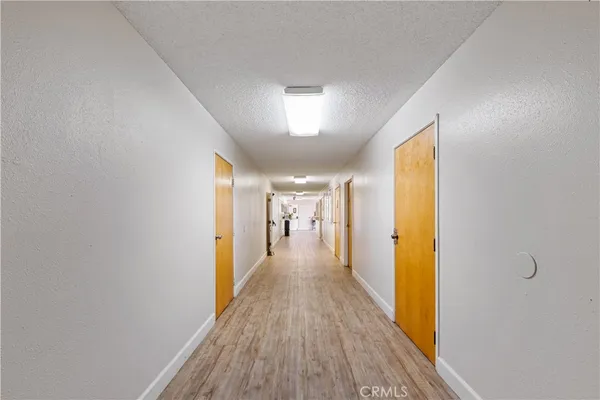 a view of a hallway with wooden floor