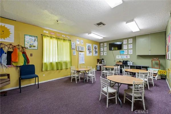 a view of a dining room with furniture and a window