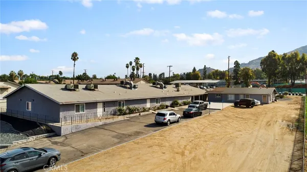 a view of a house with cars parked