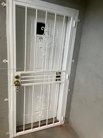 wooden floor with view of bathroom