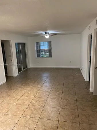 a view of a livingroom with wooden floor and a window