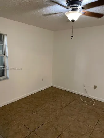an empty room with a ceiling fan