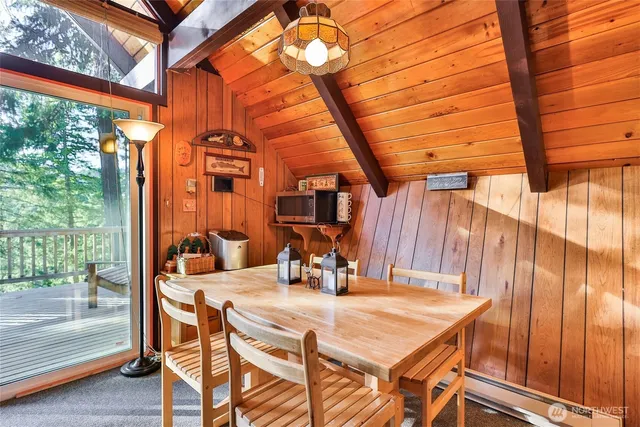 a living room with furniture a large window and a fireplace