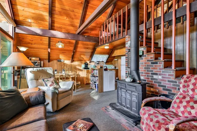 a living room with furniture and a floor to ceiling window