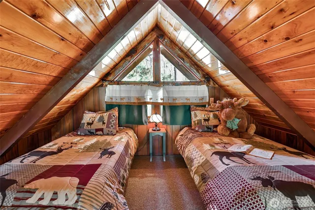 a bed sitting in a bedroom next to a window